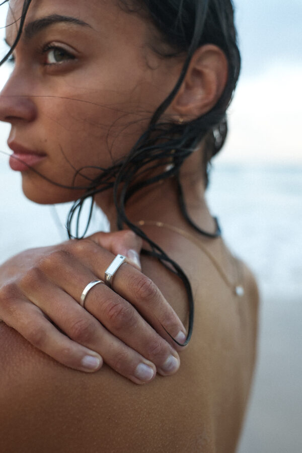 model wearing urban sterling 940 argentium silver helios signet ring and liscio