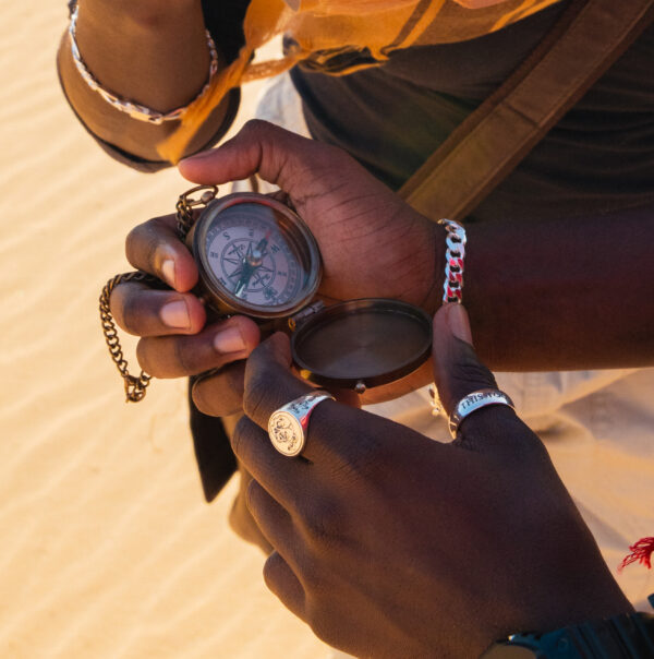 pathfinders in the desert wearing urban sterling 940 argentium rings and chains and holding compass